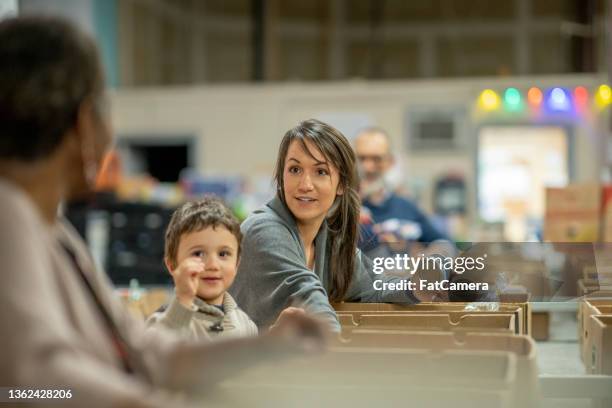 packing food donations together - food pantry stock pictures, royalty-free photos & images