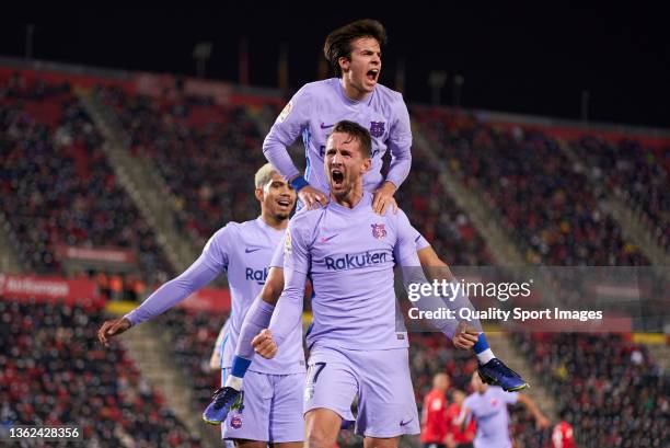 Luuk de Jong of FC Barcelona celebrates after scoring their side's first goal with his teammate Riqui Puig during the LaLiga Santander match between...