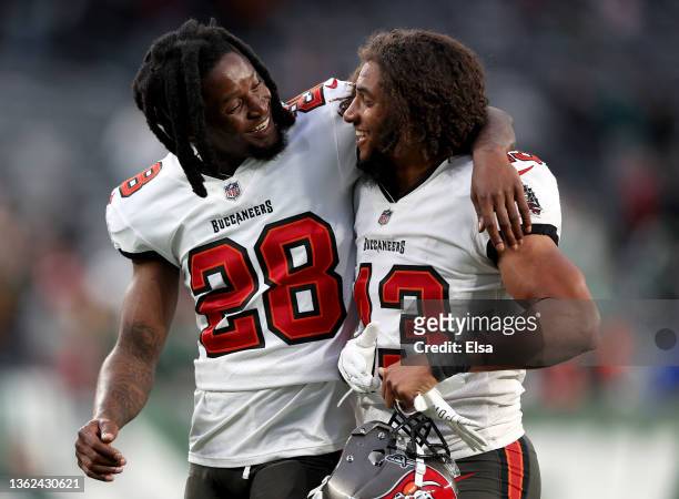 Rashard Robinson and Ross Cockrell of the Tampa Bay Buccaneers walk off the field after a 28-24 win over the New York Jets at MetLife Stadium on...