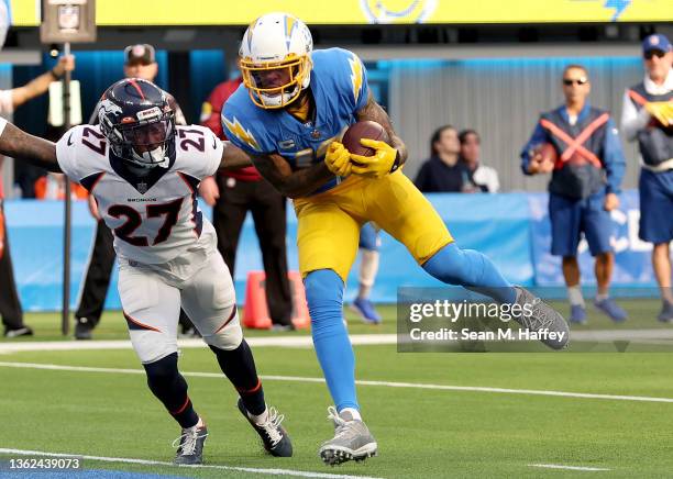 Keenan Allen of the Los Angeles Chargers completes a 8-yard touchdown pass over Nate Hairston of the Denver Broncos in the second quarter of the game...