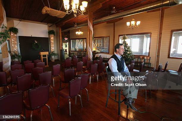 Republican presidential candidate former U.S. Senator Rick Santorum sits for a television interview following a campaign stop at The Button Factory...