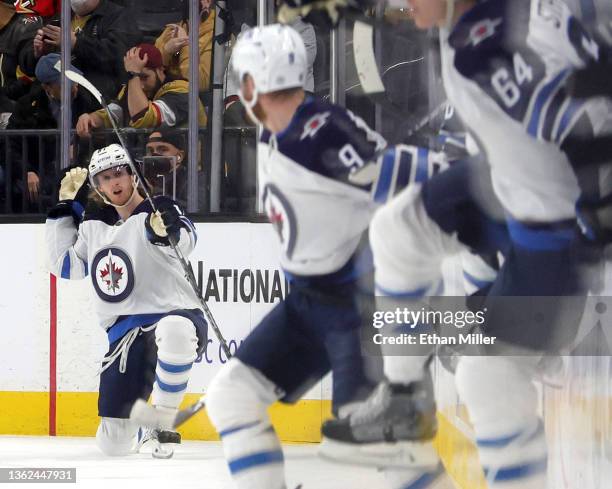 Kyle Connor of the Winnipeg Jets celebrates after scoring a goal in overtime against the Vegas Golden Knights to win their game 5-4 as teammates jump...