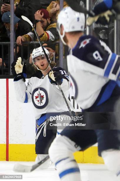 Kyle Connor of the Winnipeg Jets celebrates after scoring a goal in overtime against the Vegas Golden Knights to win their game 5-4 as teammates jump...