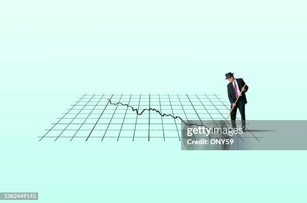 businessman sweeping up the financial carnage - volatility stock pictures, royalty-free photos & images