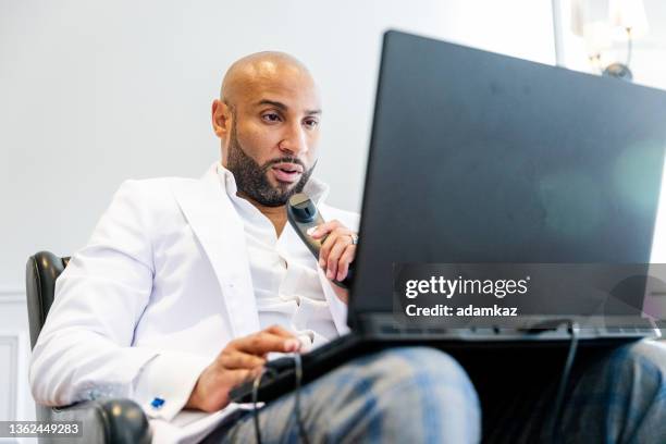 black male radiologist doctor reading x ray images on laptop from home - diktera bildbanksfoton och bilder