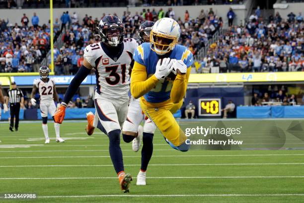 Mike Williams of the Los Angeles Chargers completes a 45-yard touchdown over Justin Simmons of the Denver Broncos in the fourth quarter of the game...