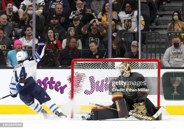 Josh Morrissey of the Winnipeg Jets and Laurent Brossoit of the Vegas Golden Knights react after Morrissey assisted Kyle Connor on a goal in overtime...