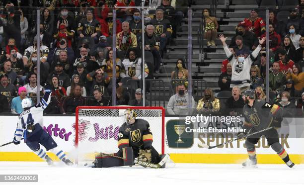 Josh Morrissey of the Winnipeg Jets and Laurent Brossoit and Alex Pietrangelo of the Vegas Golden Knights react after Morrissey assisted Kyle Connor...