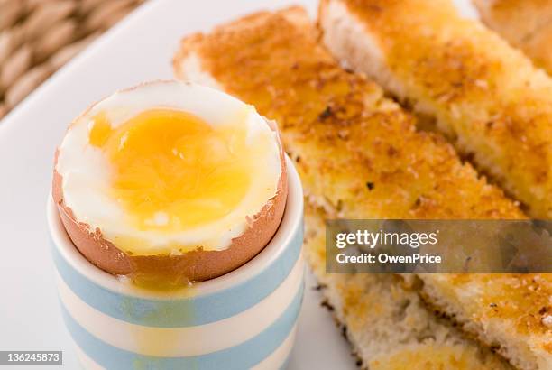 boiled egg and soldiers close up - egg yolk stock pictures, royalty-free photos & images