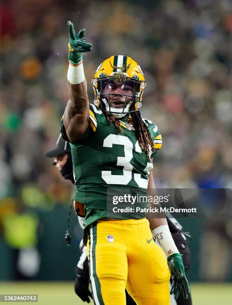 Running back Aaron Jones of the Green Bay Packers signals after a first down during the 1st quarter of the game against the Minnesota Vikings at...