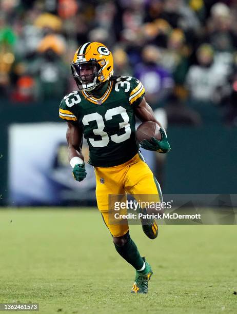 Running back Aaron Jones of the Green Bay Packers carries the ball for a first down during the 1st quarter of the game against the Minnesota Vikings...