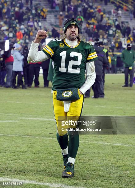 Quarterback Aaron Rodgers of the Green Bay Packers pumps his fist while walking off the field after the game against the Minnesota Vikings at Lambeau...