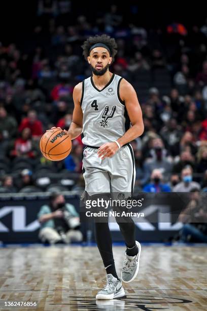 Derrick White of the San Antonio Spurs handles the ball against the Detroit Pistons at Little Caesars Arena on January 01, 2022 in Detroit, Michigan....