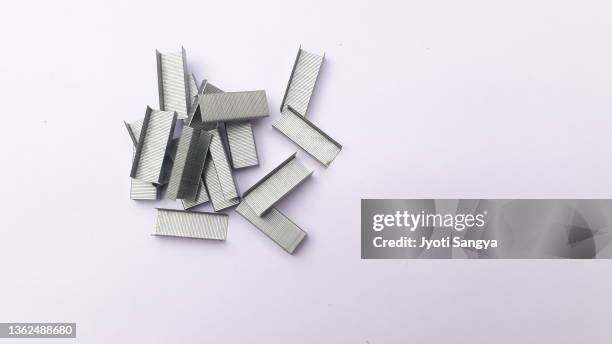 financial concepts and visual metaphors - metal stapler stock pictures, royalty-free photos & images
