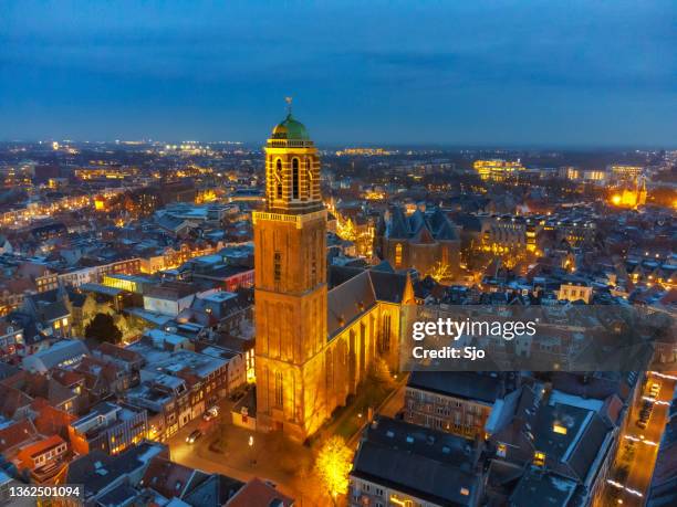 peperbus church tower nighttime drone view in the city of zwolle, overijssel during winter - zwolle stock pictures, royalty-free photos & images