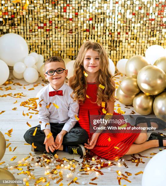 cute little brother and sister on birthday party - girl gold dress stock pictures, royalty-free photos & images