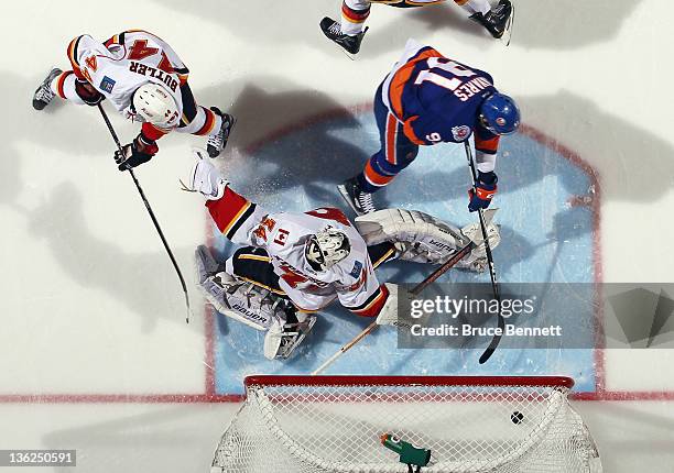 John Tavares of the New York Islanders scores the game winning goal at 3:20 of the third period against Miikka Kiprusoff of the Calgary Flames at the...