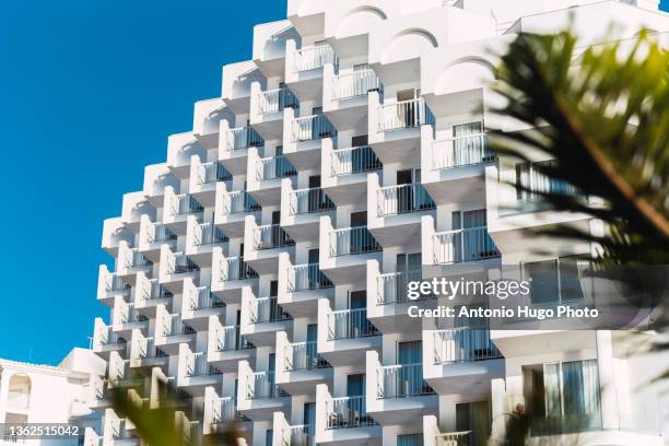 white hotel building with square-shaped balconies over blue sky. - andalucia stock pictures, royalty-free photos & images