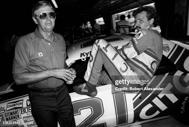 Driver Kyle Petty climbs into his race car in the Daytona International Speedway garage during a practice session for the 1988 Firecracker 400 on...