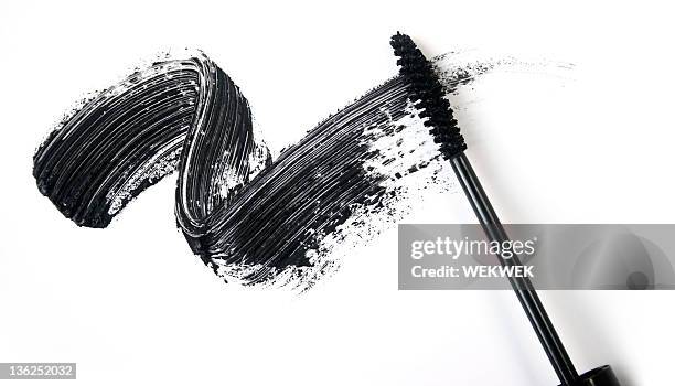 a smear of black eye liner from a mascara brush - smudged stockfoto's en -beelden