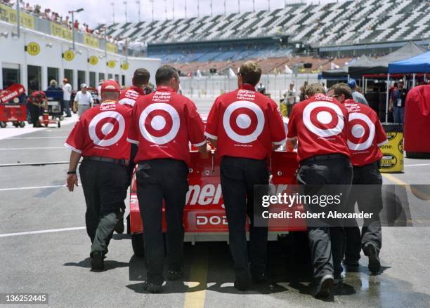 Crew members for NASCAR driver Casey Mears push his No. 41 Target-sponsored race car toward the NASCAR inspection station prior to the 2005 Daytona...