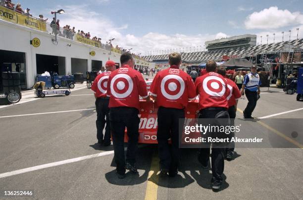 Crew members for NASCAR driver Casey Mears push his No. 41 Target-sponsored race car toward the NASCAR inspection station prior to the 2005 Daytona...