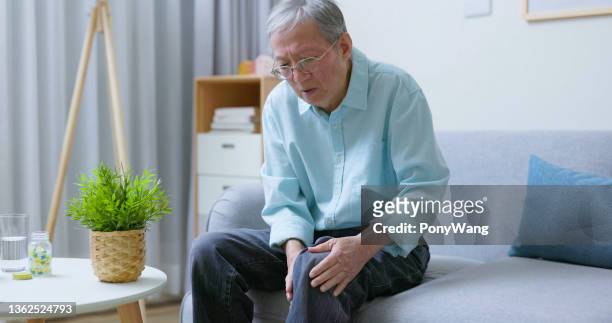 man holding knee with pain - joint effort stock pictures, royalty-free photos & images