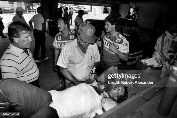 Driver Kyle Petty is administered oxygen in the Daytona International Speedway garage as he cools off after completing the 1987 Firecracker 400 on...