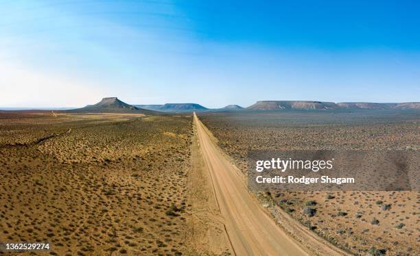 aerial view of a rural road leading to “nowhere” ... - the karoo stockfoto's en -beelden