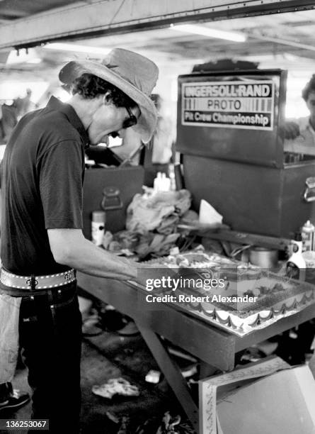 Richard Petty, driver of the STP Pontiac, cuts his birthday cake in the Daytona International Speedway garage prior to the 1986 Firecracker 400 on...