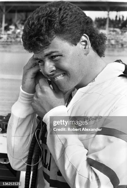 Driver Michael Waltrip stands beside his race car prior to the start of the 1987 Firecracker 400 on July 4, 1987 at the Daytona International...