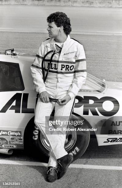 Driver Michael Waltrip stands beside his race car prior to the start of the 1987 Firecracker 400 on July 4, 1987 at the Daytona International...