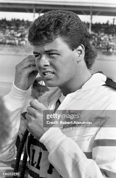 Driver Michael Waltrip stands beside his race car prior to the start of the 1987 Firecracker 400 on July 4, 1987 at the Daytona International...