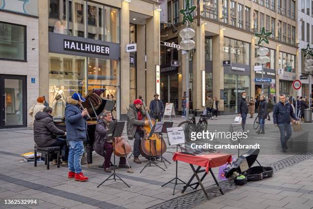 small orchestra playing in a pedestrian area in munich - orchestra outside stock pictures, royalty-free photos & images
