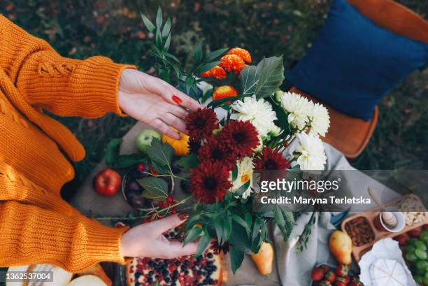 a bouquet of chrysanthemums on the background of a beautifully served table. autumn atmosphere. - autumn bouquet stock pictures, royalty-free photos & images
