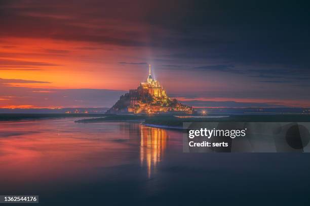 le mont saint michel at sunset in normandy, france - french chateau stock pictures, royalty-free photos & images