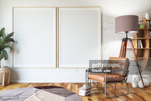 zwei vertikale leere poster modellieren eine weiße wand im innenraum mit sessel und büchern - poster wall stock-fotos und bilder
