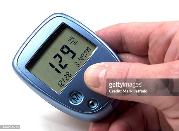 high blood sugar reading on a blue device - vertigo stock pictures, royalty-free photos & images