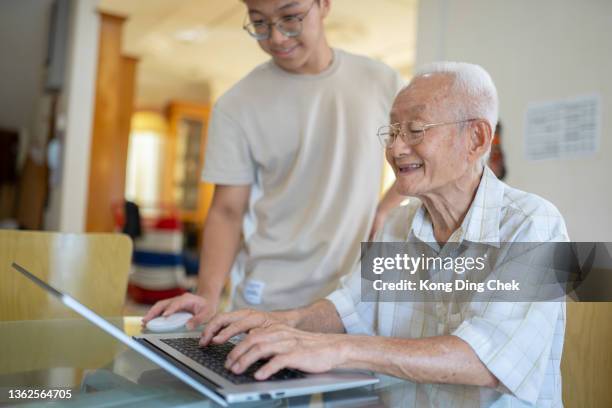 asian chinese grandfather learning internet teaching by grandchild at home. - chinese tutor study stock pictures, royalty-free photos & images