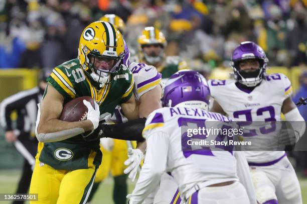 Equanimeous St. Brown of the Green Bay Packers is brought down by Harrison Smith and Mackensie Alexander of the Minnesota Vikings during a game at...