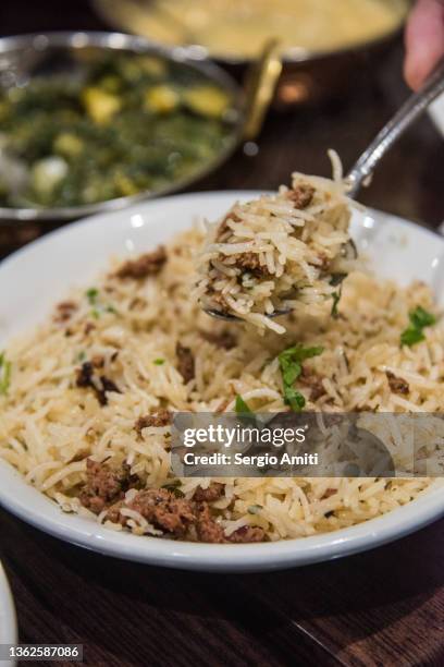 serving indian lamb biryani - pilau rice stock pictures, royalty-free photos & images