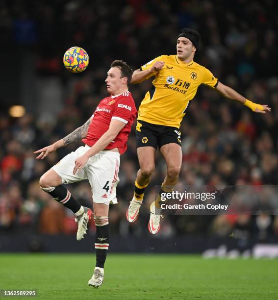 Phil Jones of Manchester United and Raul Jimenez of Wolverhampton Wanderers battle for possession during the Premier League match between Manchester...