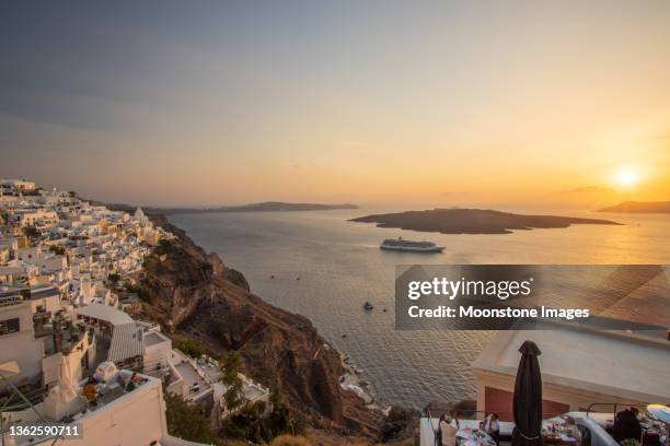 sunset over santorini caldera from firá on south aegean islands, greece - fira santorini stock pictures, royalty-free photos & images