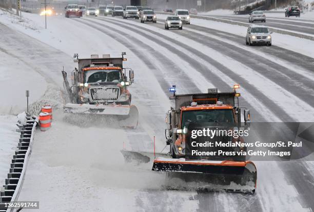 Minnesota Department of Transportation snow plows clear Interstate 94 in St. Paul, Minn. After a couple of inches of fresh snow fell on Tuesday, Dec....