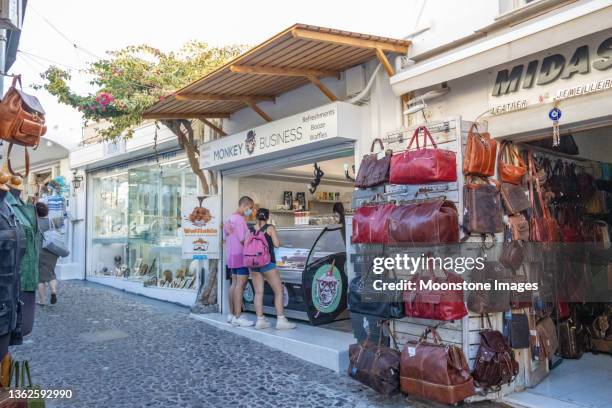 monkey business food shop in firá on santorini in south aegean islands, greece - firá stock pictures, royalty-free photos & images