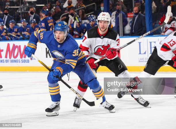 Anders Bjork of the Buffalo Sabres skates against Pavel Zacha of the New Jersey Devils during an NHL game on December 29, 2021 at KeyBank Center in...