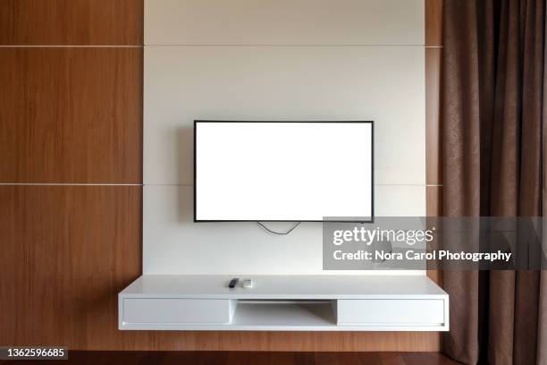 white screen tv mounted on the wall - wall of tvs stock pictures, royalty-free photos & images