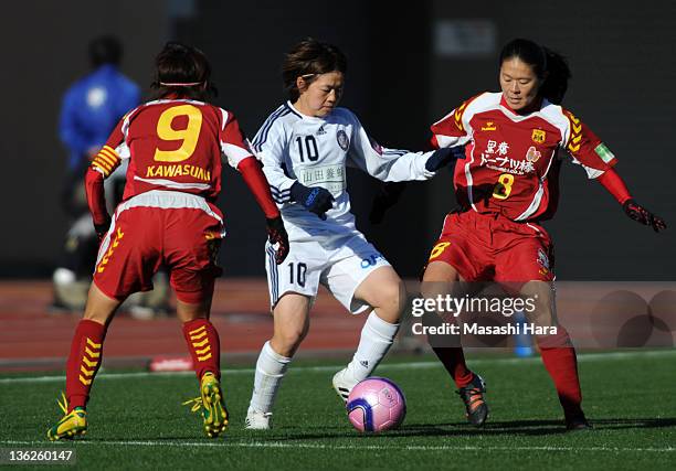 Aya Miyama of Okayama Yunogo Belle battles for the ball with Nahomi Kawasumi and Homare Sawa of INAC Kobe Leonessa during the All Japan Women's...