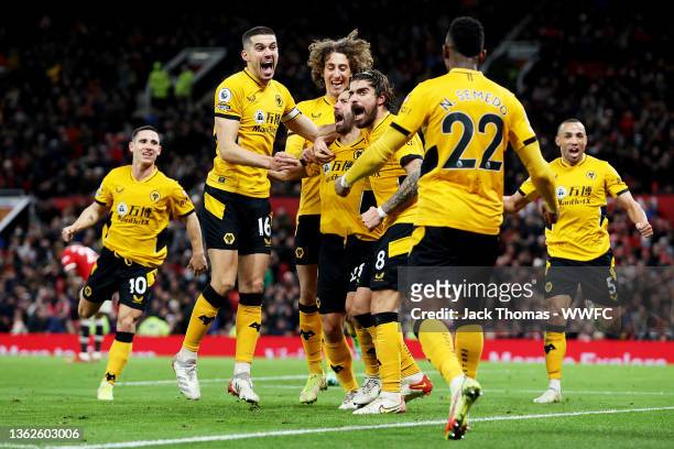 Joao Moutinho of Wolverhampton Wanderers celebrates with teammates after scoring his team's first goal during the Premier League match between...