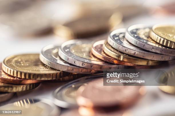 euro coins stacked in different positions. currency of the european union. - european union currency stock-fotos und bilder